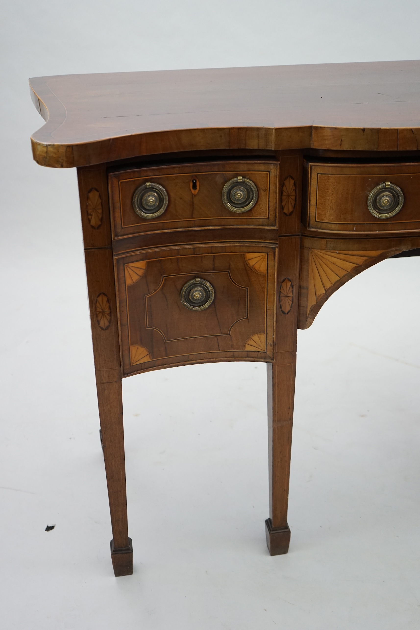 A George III inlaid mahogany serpentine sideboard